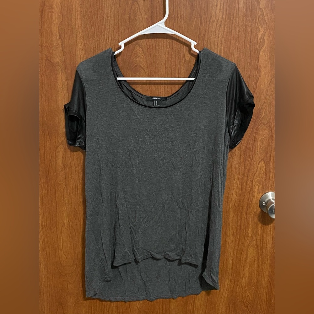 Loose-fitting soft stylish shirt with pleather-like short sleeves.